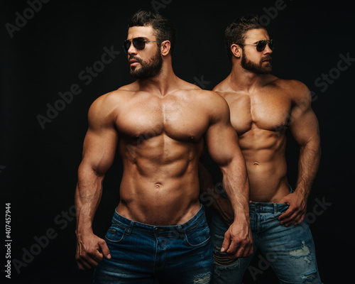 Two shirtless hunks at black background
