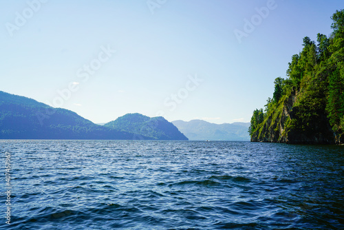 Troubled water of a large lake and mountains on the horizon        © Evgeniya Fedorova
