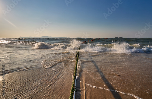 Rope holds swimming markers on a beach in position.  © Norbert