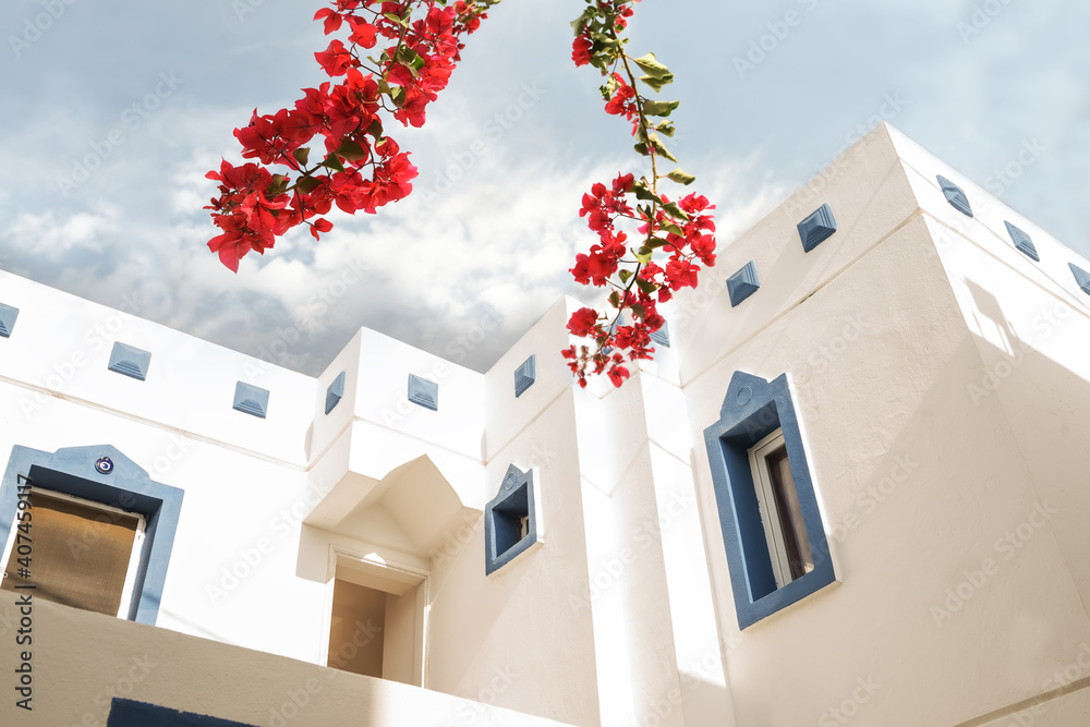 Cozy white houses with blue windows against the sky on a sunny day. Bodrum. Turkey.