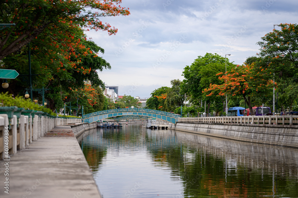Landscape of The pathway is smooth, the canal is surrounded by trees with blue sky and cloud