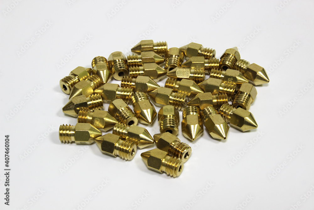 3d printer brass nozzles on white background. Additive technology component.