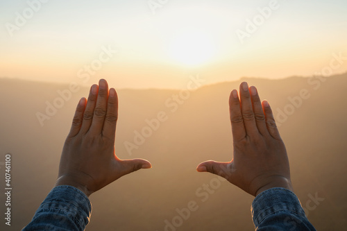 woman hand framing looking view sunrise on mountain