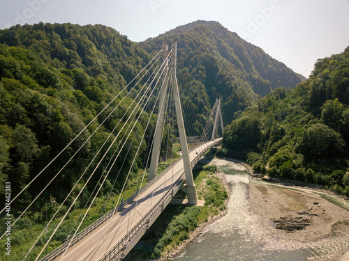 Cable-stayed bridge in the mountains covered with trees