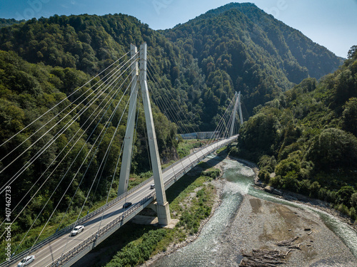 Cable-stayed bridge in the mountains covered with trees