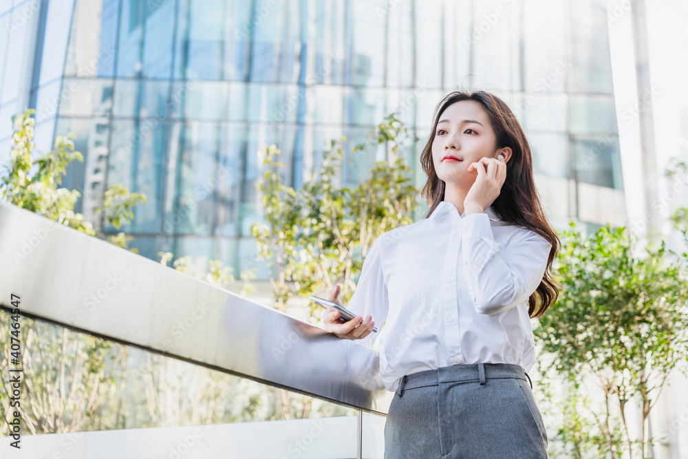 woman talking on cell phone with bluetooth headset