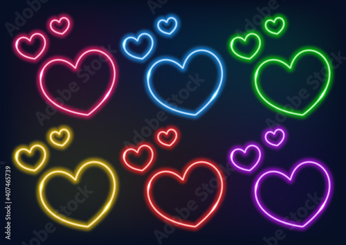 Neon frame. Set of neon hearts in different colors. Laser glowing lines on a black background. Love symbol.