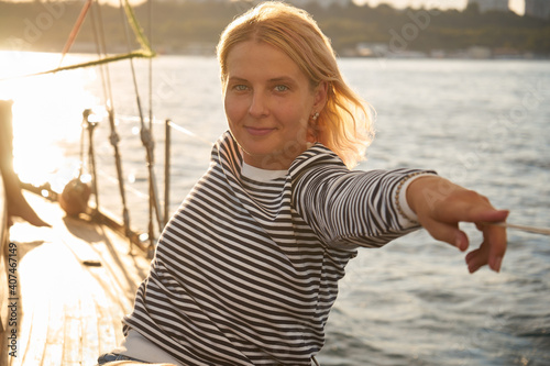 Woman resting on a yacht in the black sea at sunset
