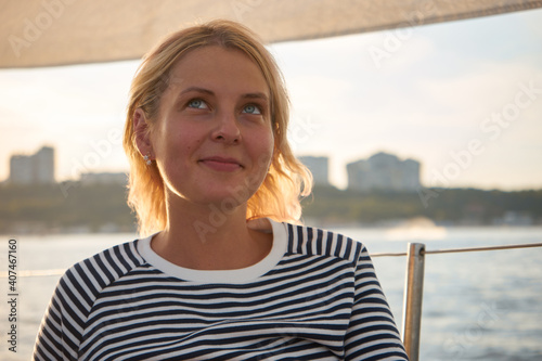 Pensive woman resting on a yacht in the black sea at sunset