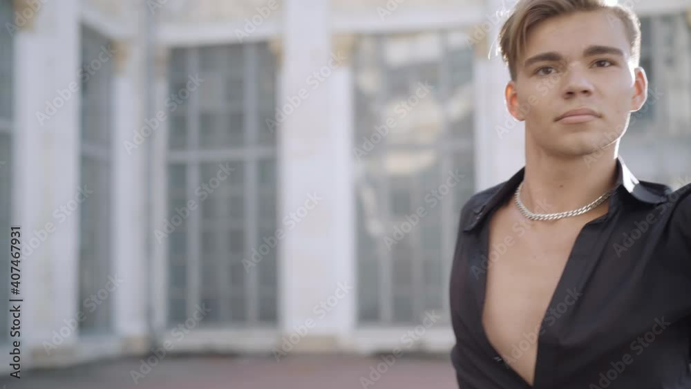 Middle shot of young ballet dancer performing outdoors in sunlight. Portrait of confident Caucasian man dancing latin ballroom dance in urban city at sunrise or sunset. Art concept. Middle shot of young ballet dancer performing outdoors in sunlight. Portrait of confident Caucasian man dancing latin ballroom dance in urban city at sunrise or sunset. Art concept.
