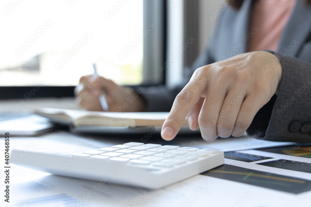 Head of accounting is recording the company's financial growth statistics using graphs as a reference for reviewing and analyzing the results, Taking notes and analyzing data graphs in office. Head of accounting is recording the company's financial growth statistics using graphs as a reference for reviewing and analyzing the results, Taking notes and analyzing data graphs in office.