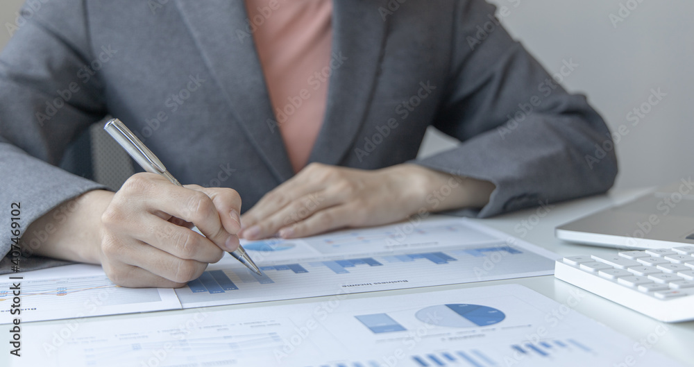 Financial businesswomen analyze the graph of the company's performance to create profits and growth, Market research reports and income statistics, Financial and Accounting concept. Financial businesswomen analyze the graph of the company's performance to create profits and growth, Market research reports and income statistics, Financial and Accounting concept.