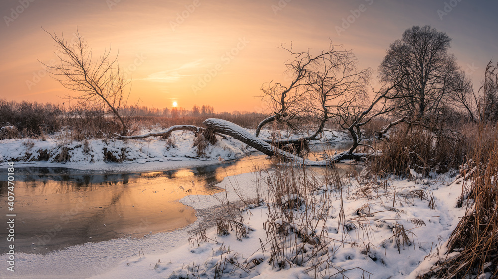 Sunset over the Jeziorka river at winter near Piaseczno, Masovia, Poland