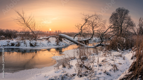 Sunset over the Jeziorka river at winter near Piaseczno, Masovia, Poland