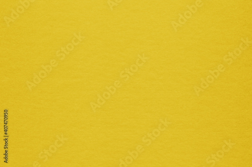 Clean yellow retro paper background. Vintage cardboard texture. Grunge paper for drawing. Simple blank fabric pattern.