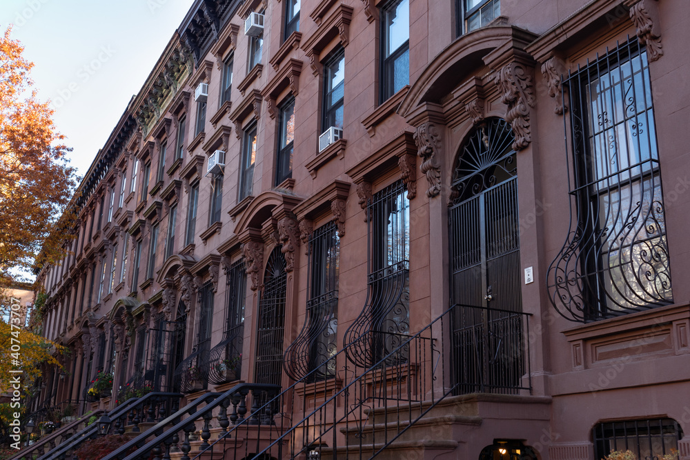 Row of Beautiful Old Brownstone Homes with Stairs in Park Slope Brooklyn New York during Autumn