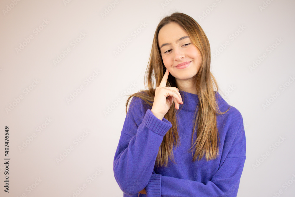 Cute playful young woman smiling and thinking over white background Cute playful young woman smiling and thinking over white background