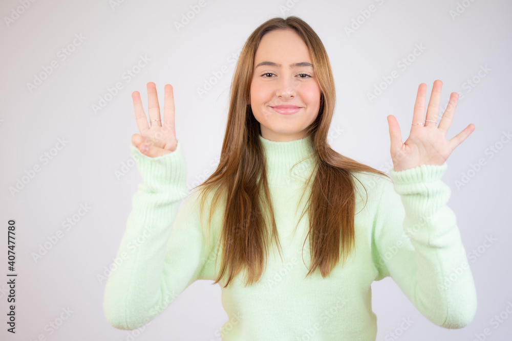 Young beautiful caucasian girl wearing casual clothes showing and pointing up with fingers number eight while smiling confident and happy. Young beautiful caucasian girl wearing casual clothes showing and pointing up with fingers number eight while smiling confident and happy.