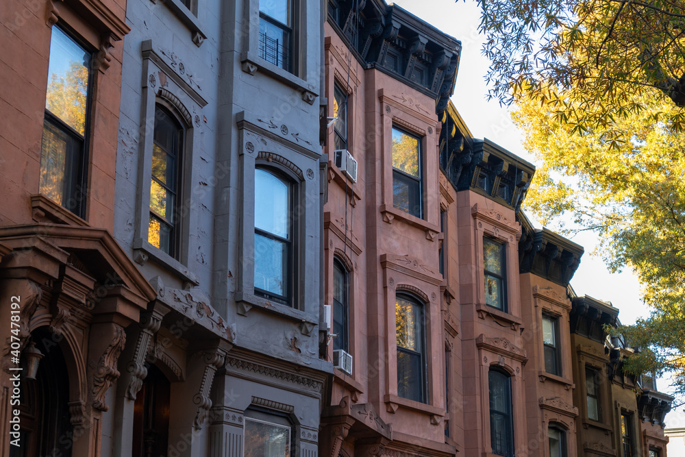 Naklejka premium Row of Colorful Old Brownstone Homes in Park Slope Brooklyn New York with Trees during Autumn