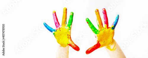 The banner is painted with bright paint the palm of your hand with different colors on a white isolated background. copy space