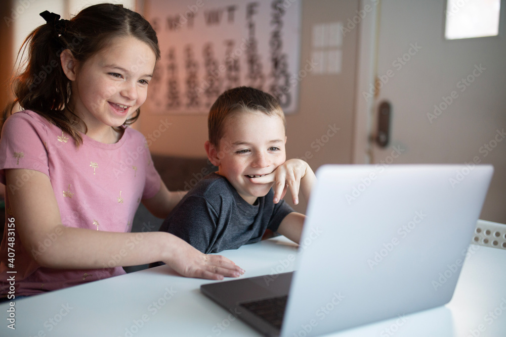 boy and girl looking at a laptop with a worried and confused look boy and girl looking at a laptop with a worried and confused look