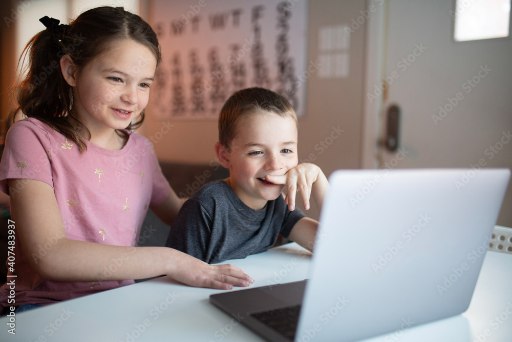 boy and girl looking at a laptop with a worried and confused look