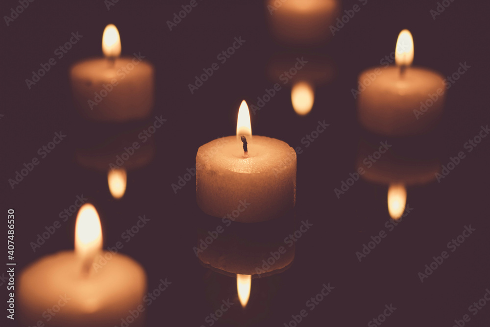 Candles burning in the dark (low-key image) Candles burning in the dark (low-key image)