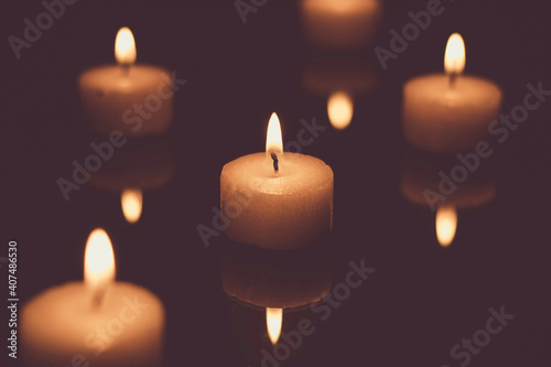 Candles burning in the dark  low-key image 