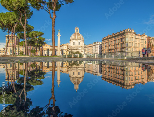 Rome, Italy - in Winter time, frequent rain showers create pools in which the wonderful Old Town of Rome reflect like in a mirror. Here in particular Via dei Fori Imperiali photo