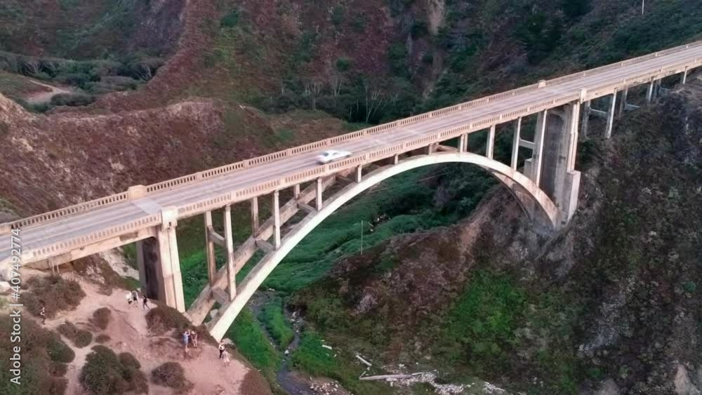 Aerial view of Bixby Creek Bridge flying backwards (car, coastline) Aerial view of Bixby Creek Bridge flying backwards (car, coastline)
