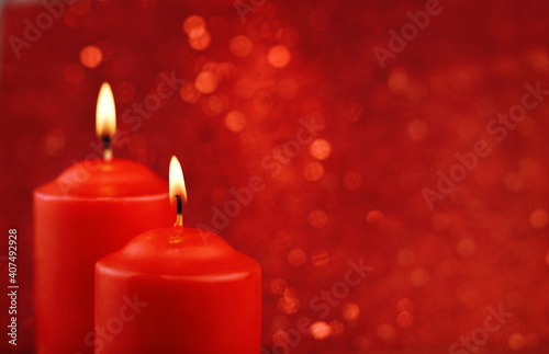 Red burning candles on red bokeh