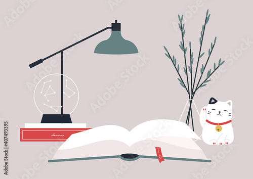 Reading a book at the desk, hobby and education, a desk decorated with a crystal globe, a lamp and a lucky cat figurine, cozy atmosphere