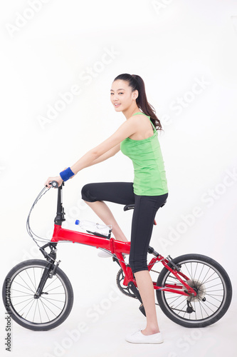 Young woman riding a bicycle © eastfenceimage