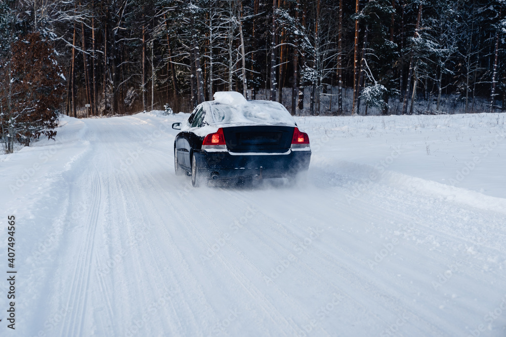 Snow covered car driving on a snowy winter forest road. Runaway from civilization to the nature.