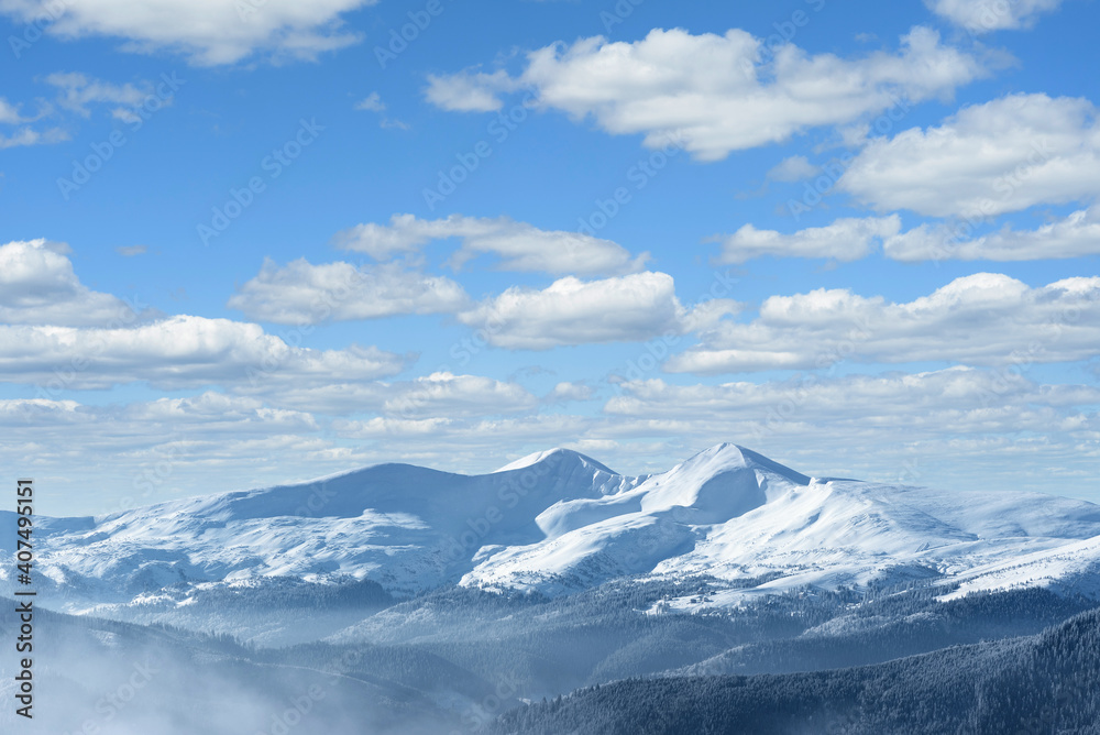 Winter landscape with snow capped mountain peaks