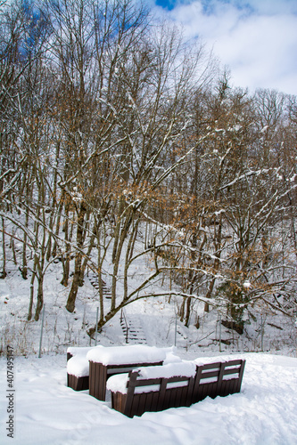 snow-covered benches in the park