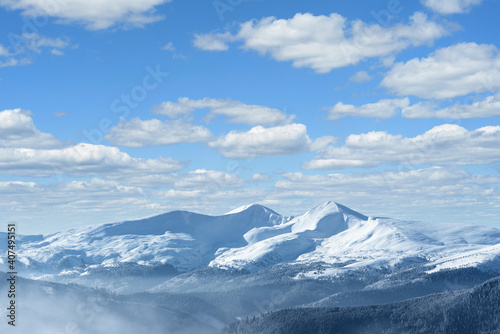 Winter landscape with snow capped mountain peaks