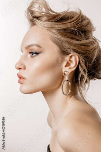 Beauty portrait of a girl with white hair, makeup and hairstyle on a white background