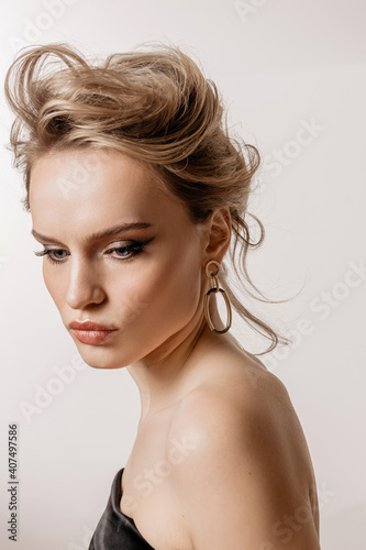 Beauty portrait of a girl with white hair, makeup and hairstyle on a white background