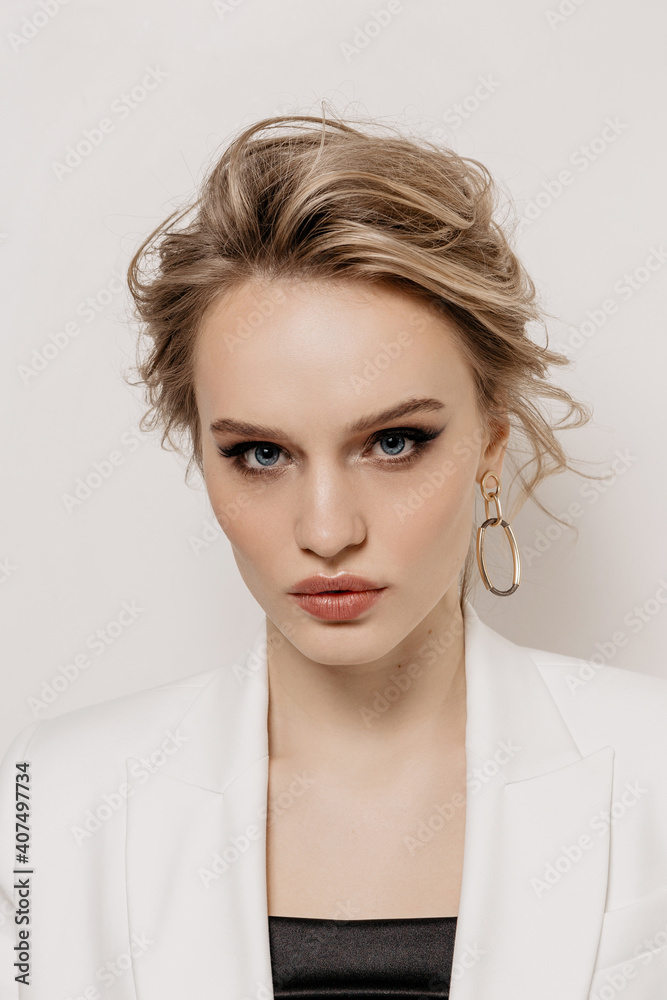 Beauty portrait of a girl with white hair, makeup and hairstyle on a white background Beauty portrait of a girl with white hair, makeup and hairstyle on a white background