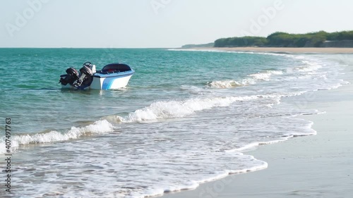 Boat besides the beach at Beyt Dwarka Island in Gujarat, India photo
