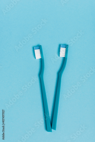 Top view of new toothbrushes on blue background