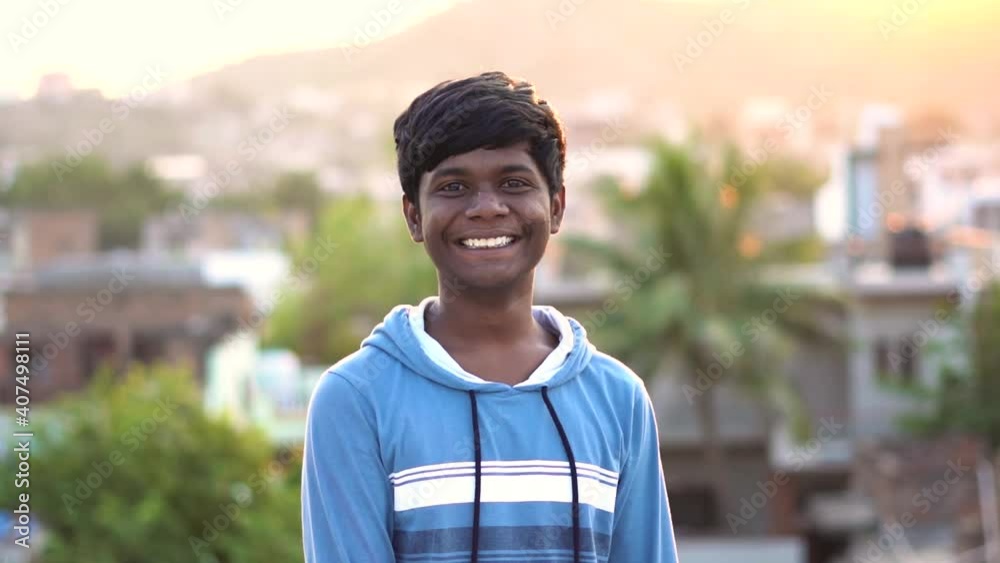 Close up portrait of the happy Indian kid smiling toward the camera and giving thumbs up during the golden hour, Happy child concept Close up portrait of the happy Indian kid smiling toward the camera and giving thumbs up during the golden hour, Happy child concept