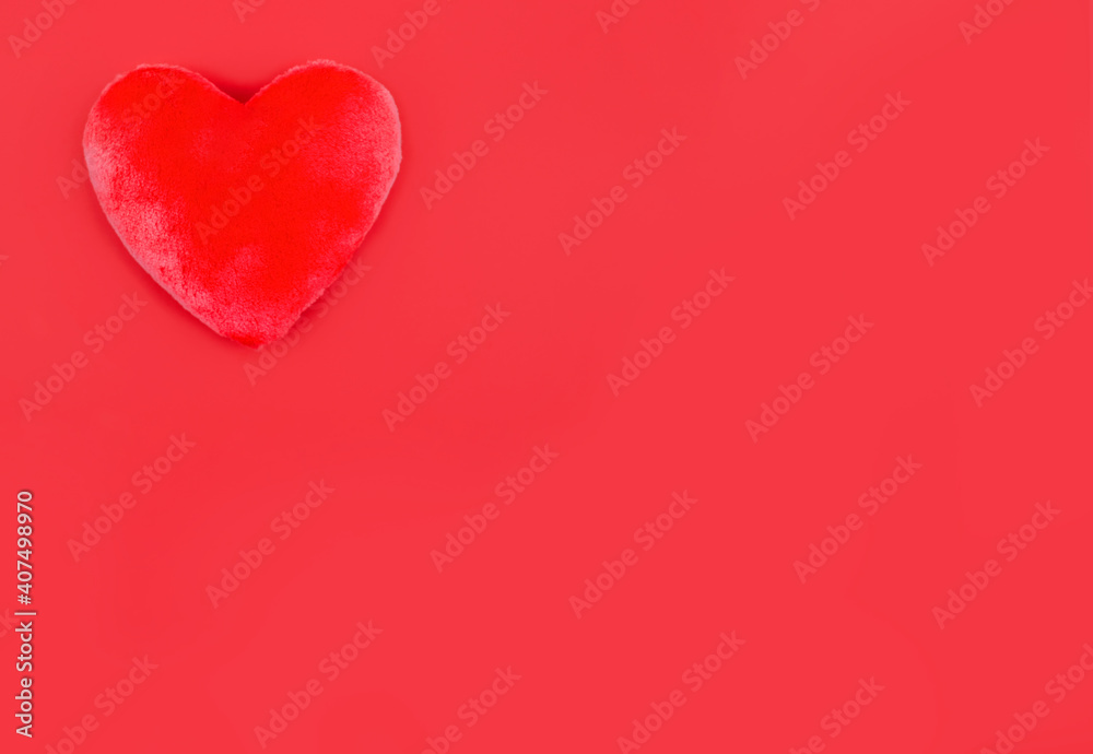 Plush red heart on red background. Copy space Plush red heart on red background. Copy space