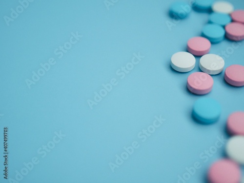 Vitamins, pills and tablets on blue background. Pharmaceutical products. Healthcare. Drug prescription for the treatment of a drug. Pharmacy theme. Copy space