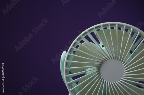 Modern electric fan on violet background, closeup. Space for text