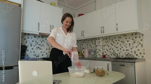 Young beautiful vlogger showing her followers how to bake cookies. Livestream concept.