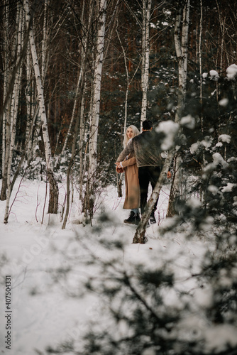 happy couple in winter forest