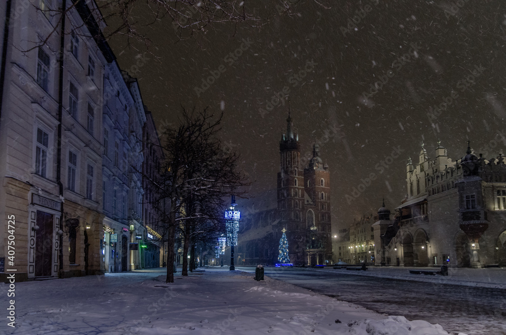 Winter in Cracow, snowy night near St. Mary's Church in Cracow marketplace