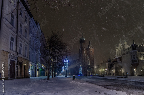 Winter in Cracow, snowy night near St. Mary's Church in Cracow marketplace